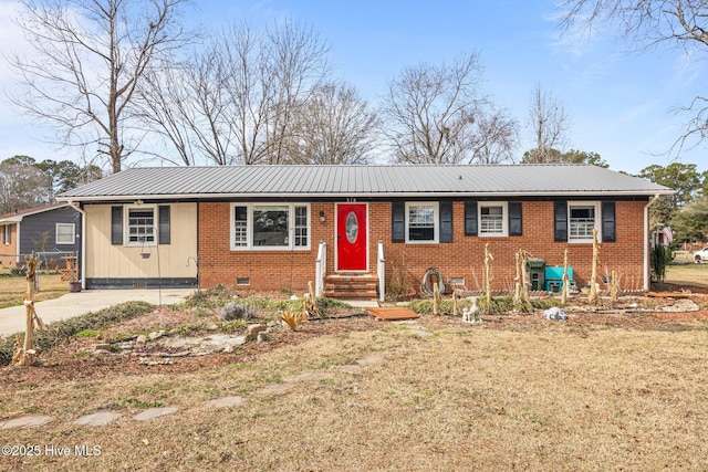 ranch-style house featuring metal roof, brick siding, and crawl space