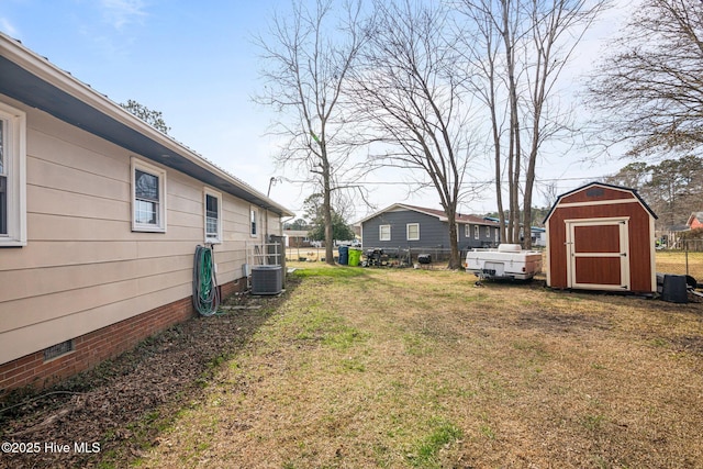 view of yard featuring a storage unit, an outdoor structure, and cooling unit