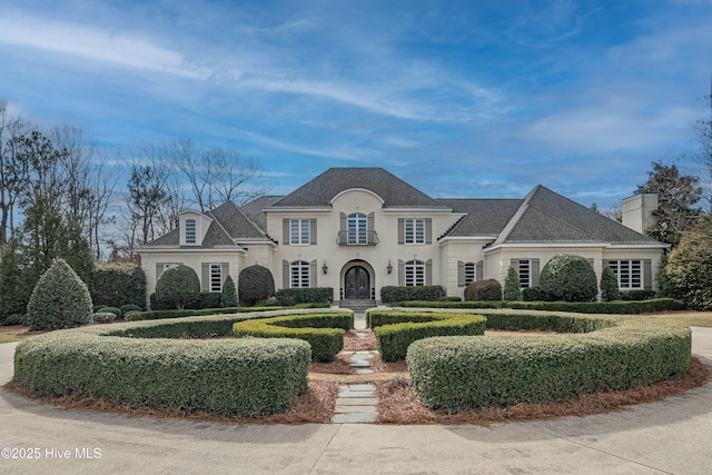 french provincial home with a chimney