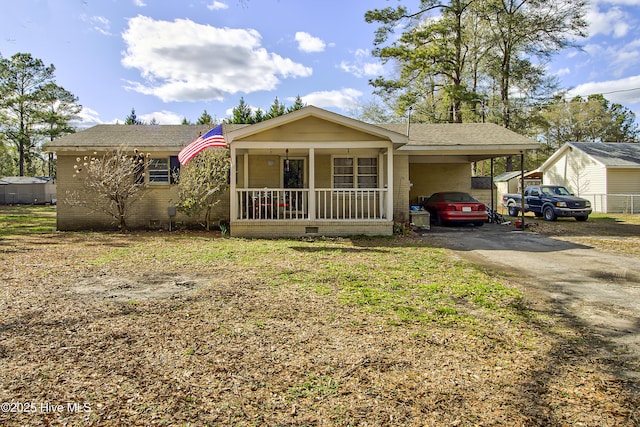 ranch-style house with driveway, a porch, crawl space, and an attached carport