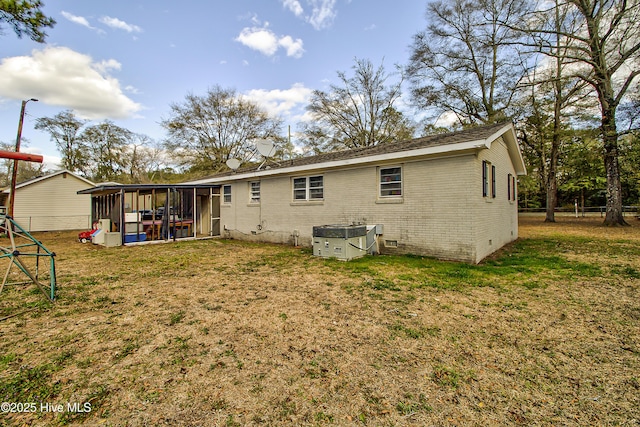 back of property featuring crawl space, a yard, a playground, and brick siding