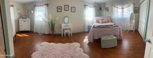 bedroom featuring baseboards and wood finished floors