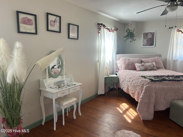 bedroom with ceiling fan, baseboards, and wood finished floors