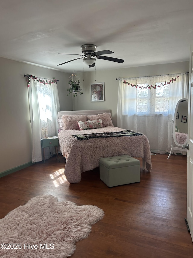 bedroom with a ceiling fan and wood finished floors