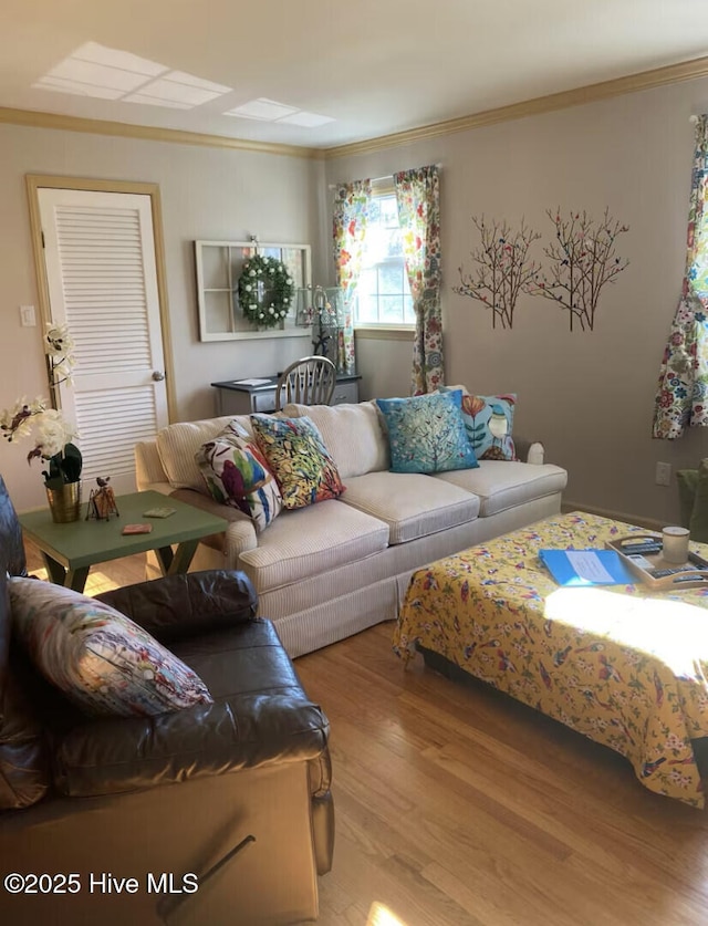 living room with ornamental molding and wood finished floors