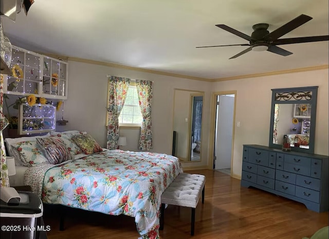 bedroom featuring ornamental molding, ceiling fan, and wood finished floors