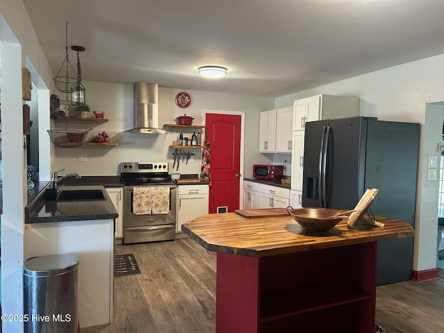 kitchen featuring wall chimney exhaust hood, open shelves, a sink, and stainless steel range with electric cooktop