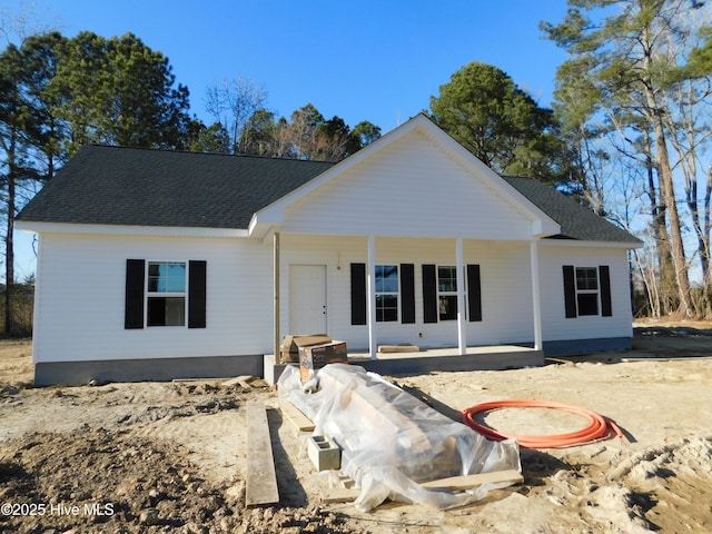 ranch-style house featuring roof with shingles