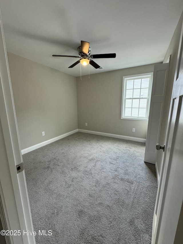 unfurnished bedroom with baseboards, carpet, and a ceiling fan