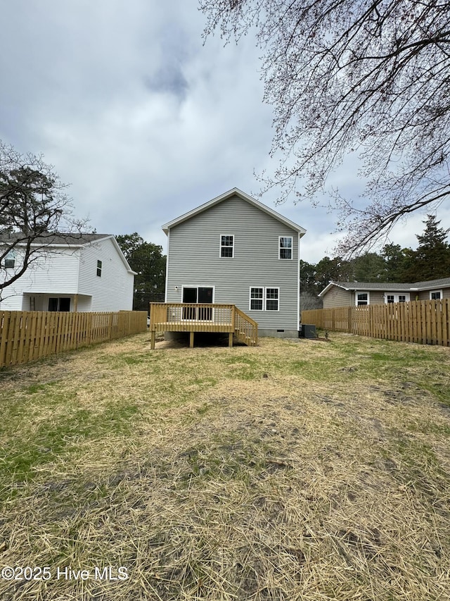 rear view of property with crawl space, central AC unit, a deck, and fence