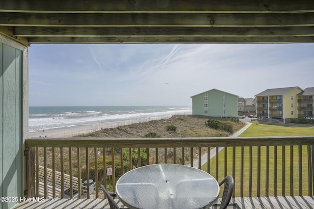 918 N New River Dr Unit 728, Surf City, NC 28445 - wooden terrace with a water view, outdoor dining space, a beach view, and a lawn