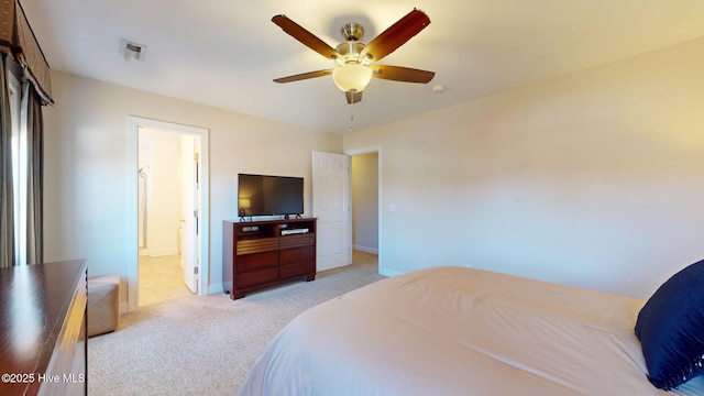 bedroom featuring light colored carpet, visible vents, ceiling fan, ensuite bath, and baseboards