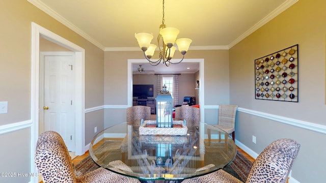 dining room featuring a chandelier, ornamental molding, and wood finished floors