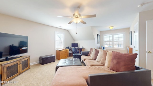 carpeted living area featuring vaulted ceiling, a ceiling fan, and baseboards