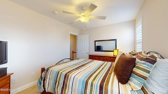 bedroom with ceiling fan, carpet floors, and baseboards