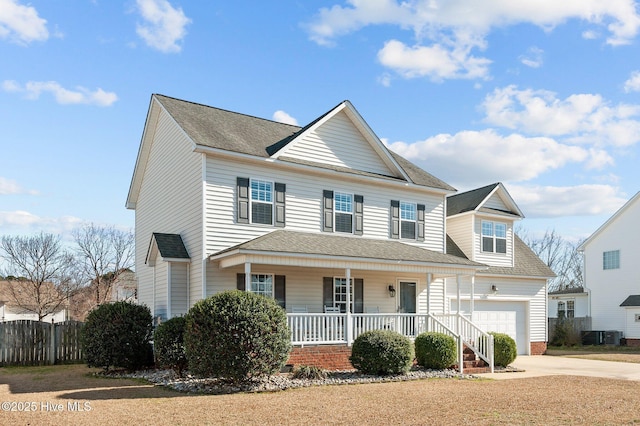 view of front of property featuring a porch, a shingled roof, fence, a garage, and driveway