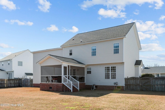 back of property featuring a shingled roof, a lawn, a sunroom, a fenced backyard, and crawl space