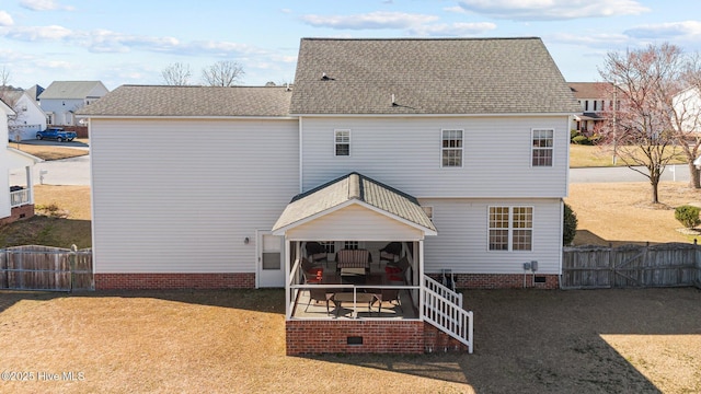 rear view of property with crawl space, fence, a patio, and a gate