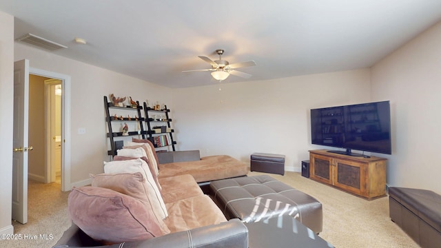 carpeted living room featuring a ceiling fan, visible vents, and baseboards