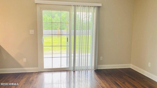 entryway with baseboards and dark wood finished floors