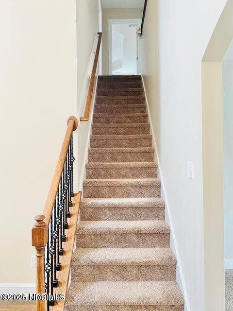 stairs featuring baseboards