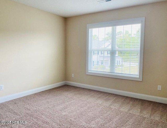 spare room with carpet flooring and baseboards