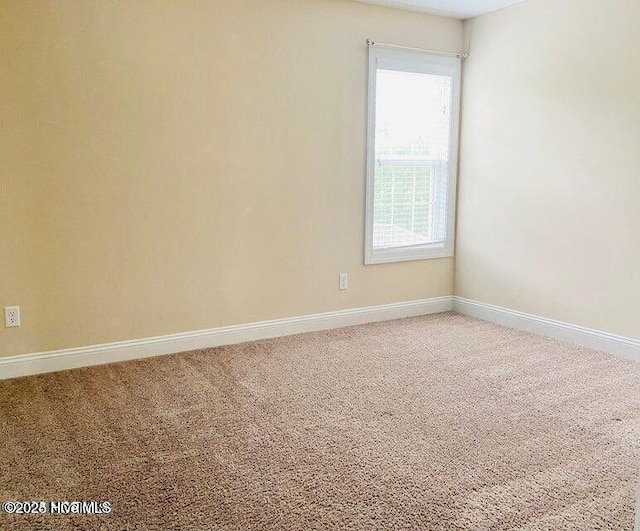 empty room with carpet flooring and baseboards