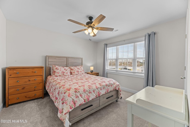 bedroom featuring baseboards, ceiling fan, visible vents, and light colored carpet