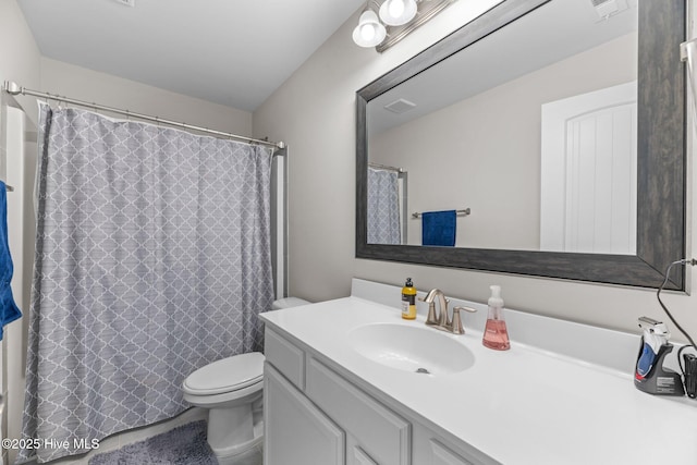 bathroom with toilet, visible vents, a shower with shower curtain, and vanity