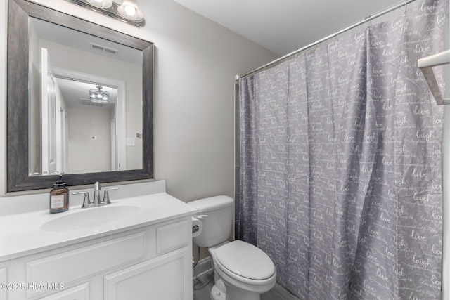 bathroom with toilet, visible vents, and vanity