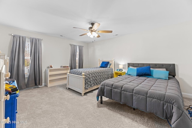 bedroom with carpet floors, visible vents, baseboards, and a ceiling fan