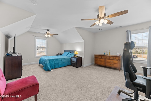 carpeted bedroom with vaulted ceiling, a ceiling fan, and baseboards