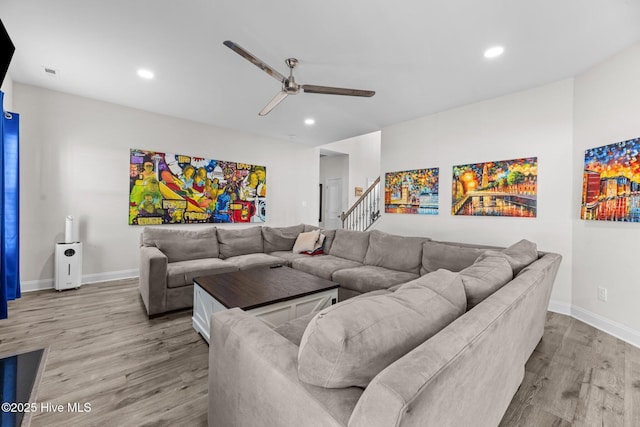 living area featuring recessed lighting, baseboards, ceiling fan, and light wood finished floors