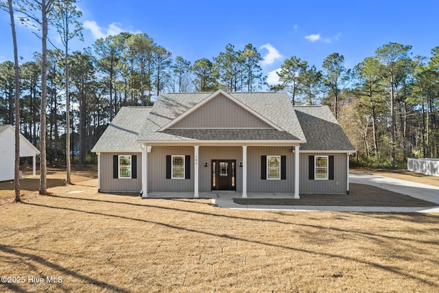 195 Boundary Loop Rd NW, Calabash, NC 28467 - modern farmhouse with a shingled roof and a porch
