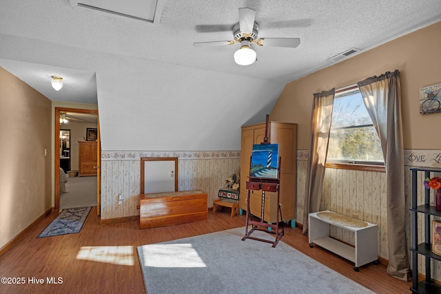 122 Charlie Lewis Ln, Beaufort, NC 28516 - bonus room featuring a ceiling fan, a wainscoted wall, wood finished floors, a textured ceiling, and lofted ceiling