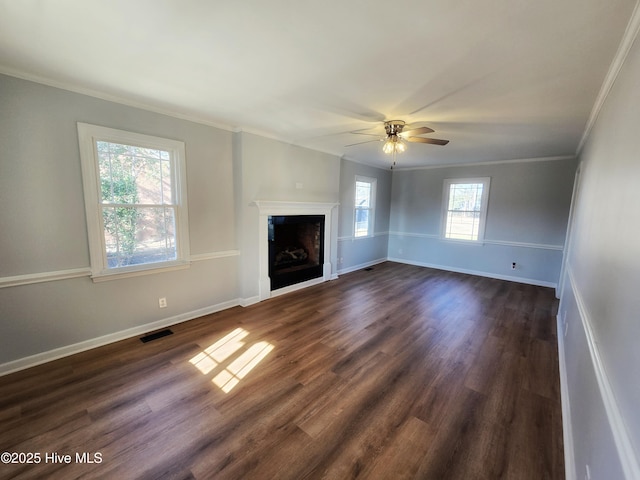 unfurnished living room featuring dark wood-style floors, baseboards, visible vents, ceiling fan, and crown molding