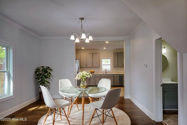 dining area featuring dark wood finished floors, a notable chandelier, baseboards, and ornamental molding