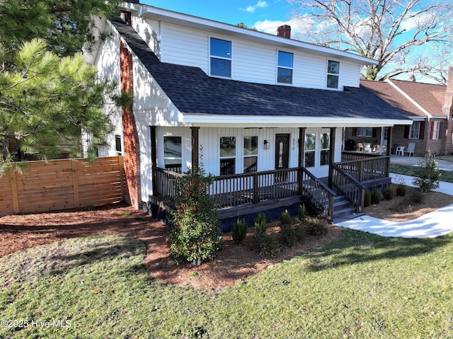 view of front facade with a shingled roof, fence, a porch, a front yard, and a chimney