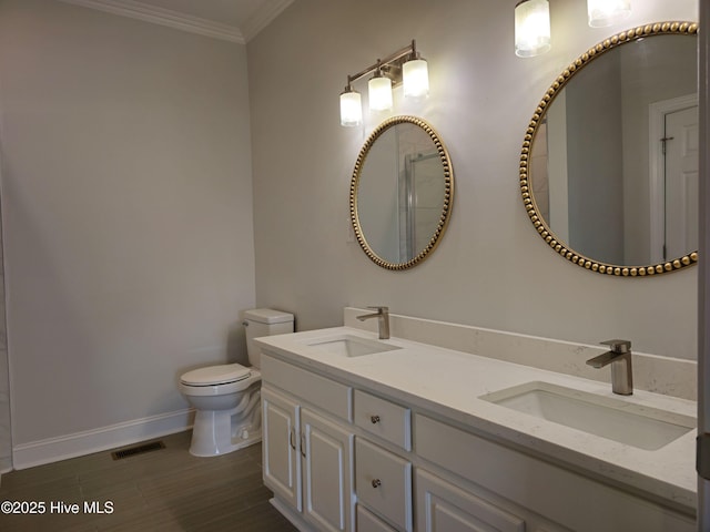 full bath featuring crown molding, toilet, visible vents, and a sink