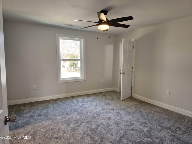 spare room with visible vents, ceiling fan, baseboards, and carpet floors