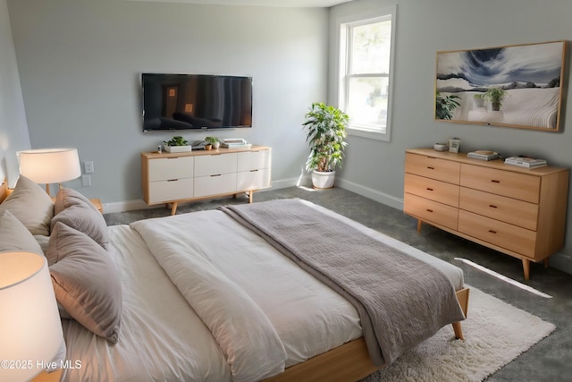 bedroom featuring carpet and baseboards