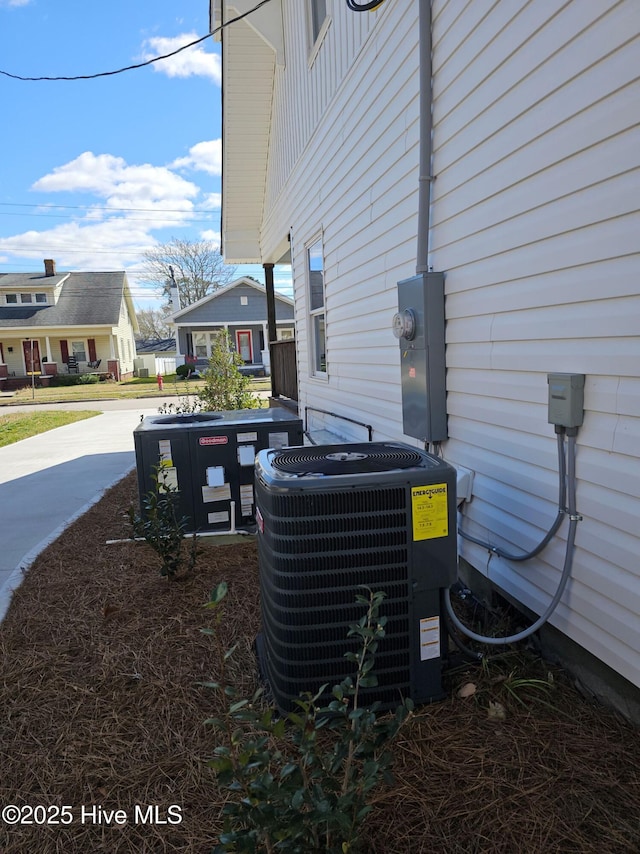 exterior details featuring a residential view, central AC, and electric meter