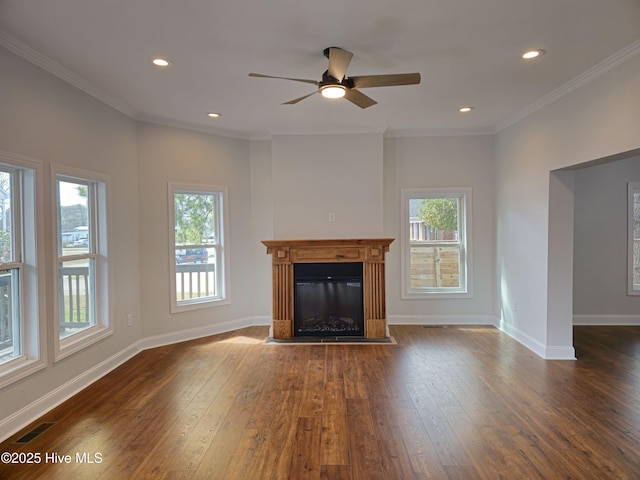 unfurnished living room featuring crown molding, dark wood-type flooring, and baseboards