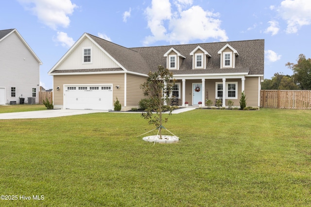 new england style home featuring driveway, roof with shingles, a front yard, and fence