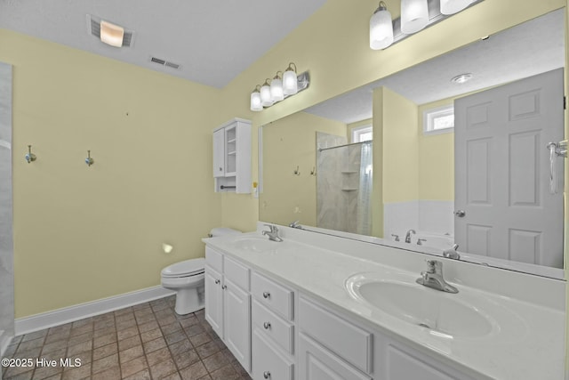 full bath with a sink, walk in shower, visible vents, and baseboards