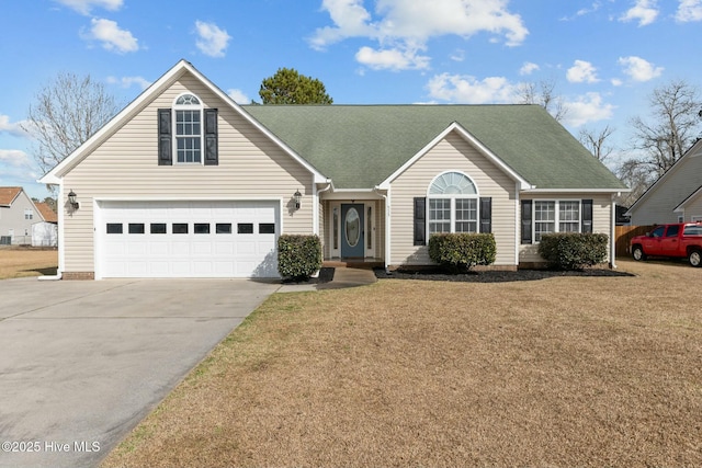 view of front of home with driveway, a shingled roof, and a front yard