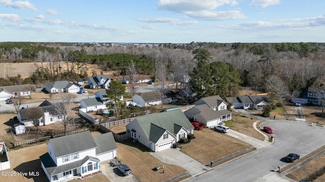 bird's eye view featuring a forest view and a residential view