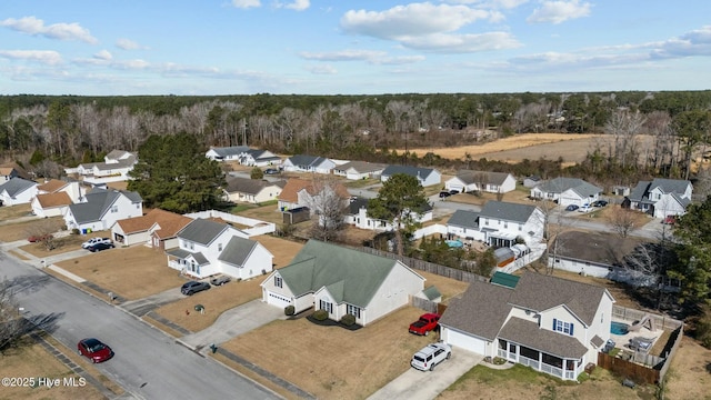 aerial view featuring a wooded view and a residential view