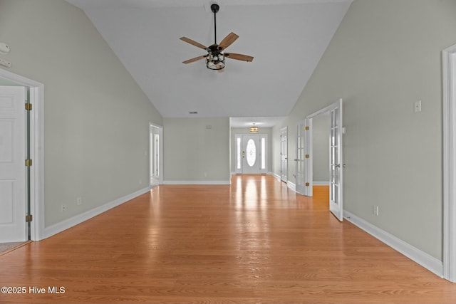 unfurnished living room with light wood-type flooring and baseboards