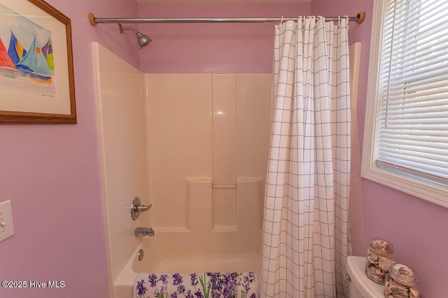 full bathroom with plenty of natural light, toilet, and shower / bath combo with shower curtain